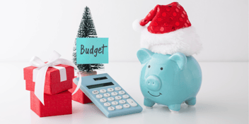 Holiday piggy bank, calculator, presents, and a tree that says budget