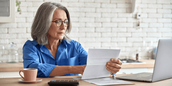 mature woman assessing financial statements