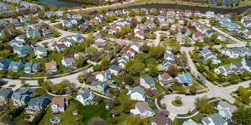 Planned community suburbs , row of suburban houses , tree lined residential street