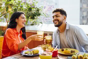 couple enjoying their food at a public setting