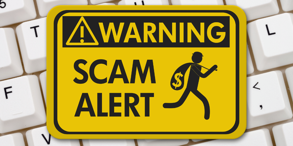 Sign that reads, Warning, Scam Alert