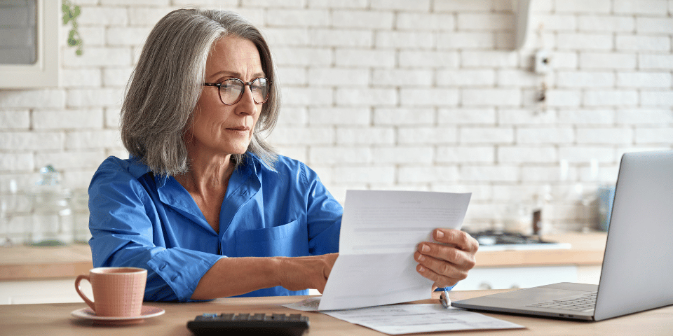 mature woman assessing financial statements
