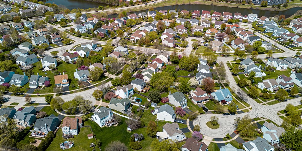 Planned community suburbs , row of suburban houses , tree lined residential street