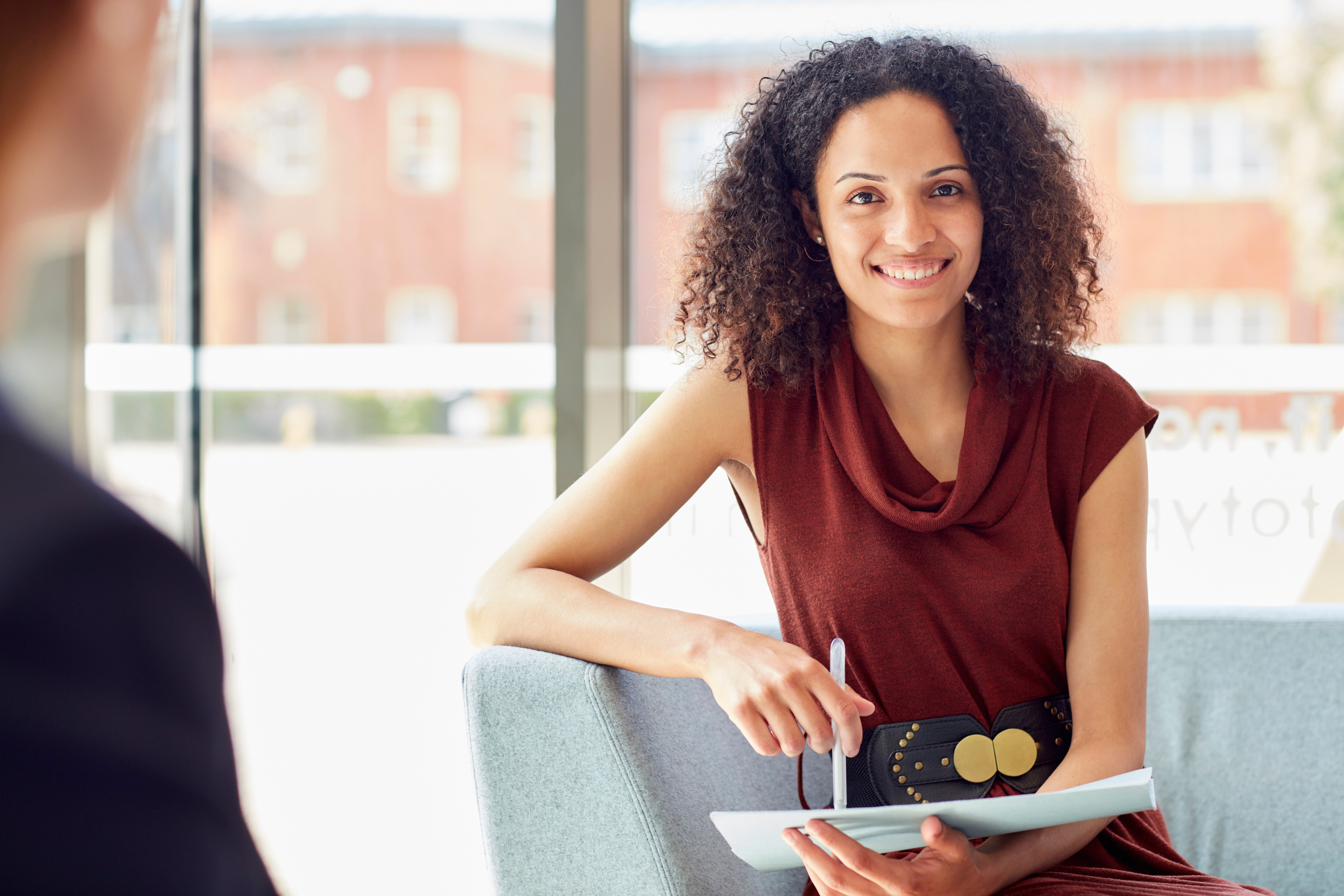 woman in credit union with tablet in hand